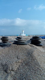 View of pebbles on beach against sky
