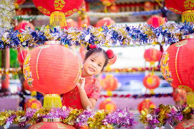 Portrait of smiling girl with multi colored flower