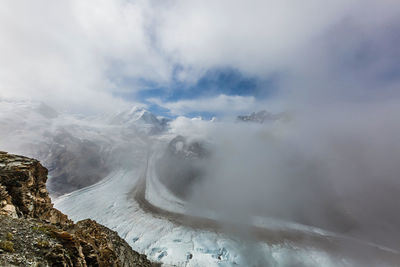 Scenic view of waterfall against sky