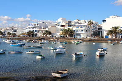 Sailboats moored in city