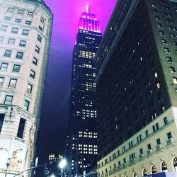 Low angle view of skyscrapers lit up at night