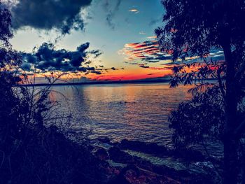 Scenic view of lake against sky at sunset