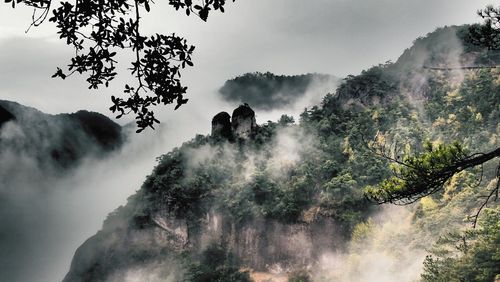 Scenic view of mountain against cloudy sky