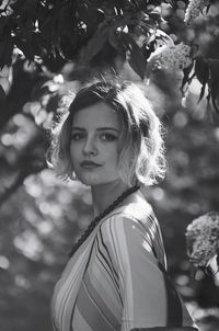 Portrait of young woman standing outdoors