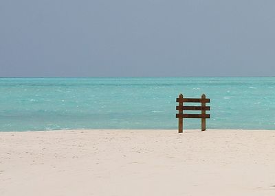 Lifeguard hut on beach against clear sky