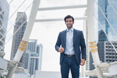 Portrait of businessman standing in city