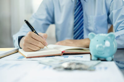 Midsection of man working on table