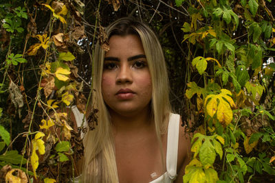 Portrait of a young woman with plants