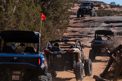 Full frame view of panoramic rugged scenery with off-road vehicles on a trail