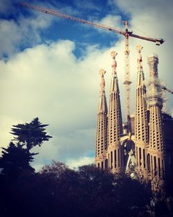 Low angle view of building under construction against sky