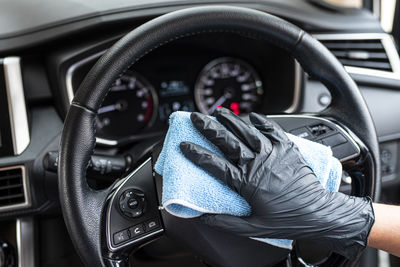 Close-up of man using smart phone in car