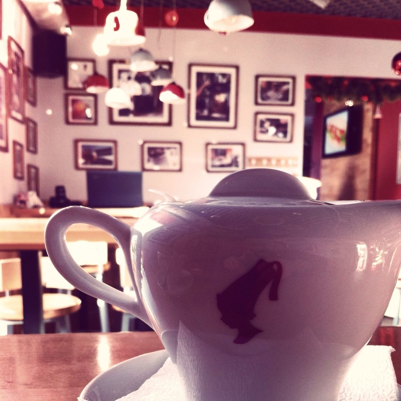 indoors, table, text, focus on foreground, western script, still life, communication, close-up, no people, animal representation, art, selective focus, art and craft, creativity, chair, coffee cup, home interior, human representation, cafe, restaurant