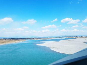 Scenic view of beach against blue sky