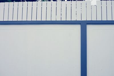 Fence on white surrounding wall