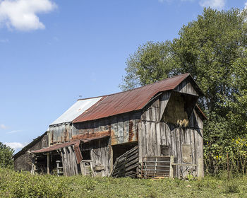 Abandoned house on field against sky