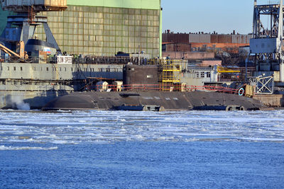 Scenic view of sea against buildings