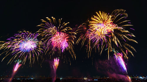 Low angle view of firework display at night