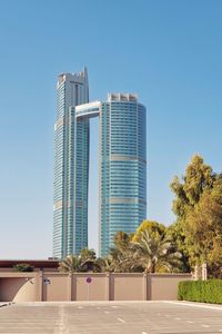 Modern buildings against clear blue sky