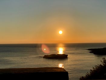 Scenic view of sea against clear sky during sunset