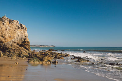 Scenic view of sea against clear blue sky