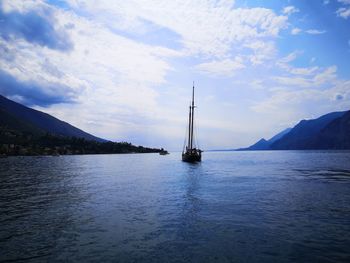 Sailboats sailing in sea against sky