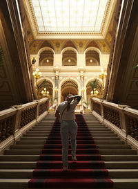 Low angle view of man walking in tunnel