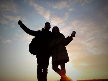 Silhouette of people at sunset