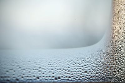 Close-up of wet car window during winter