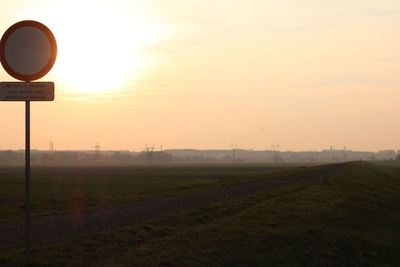 Scenic view of field against sky during sunset