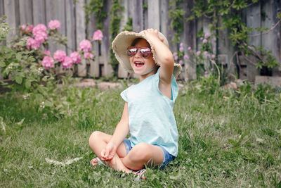 Smiling girl sitting in grass at yard