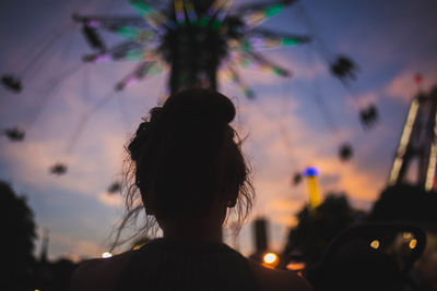 Rear view of silhouette woman looking at sunset