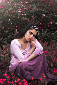 Portrait of young woman with pink flowers