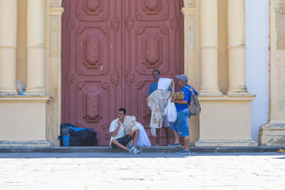 People in temple outside building