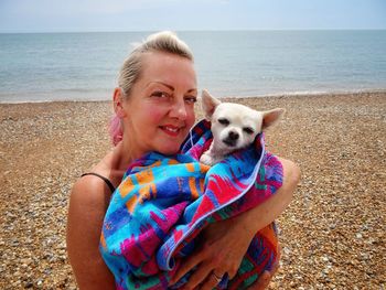 Portrait of woman dog at beach