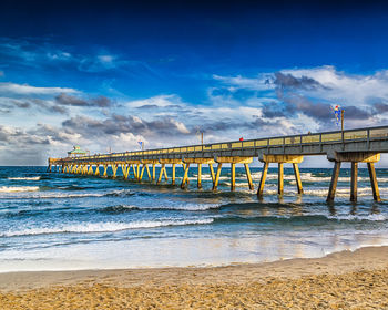 Pier over sea against sky