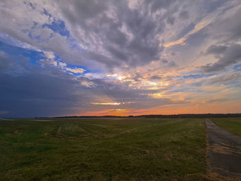 Scenic view of field against sky during sunset