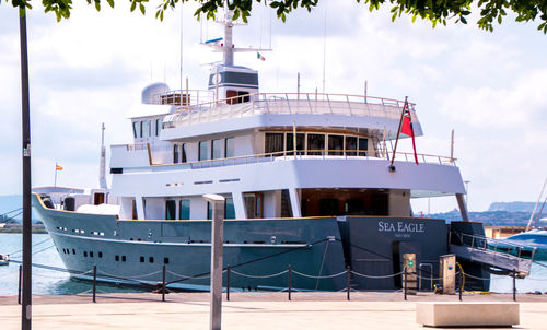 Ship moored on shore against sky