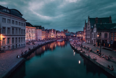 Reflection of illuminated buildings in canal at dusk