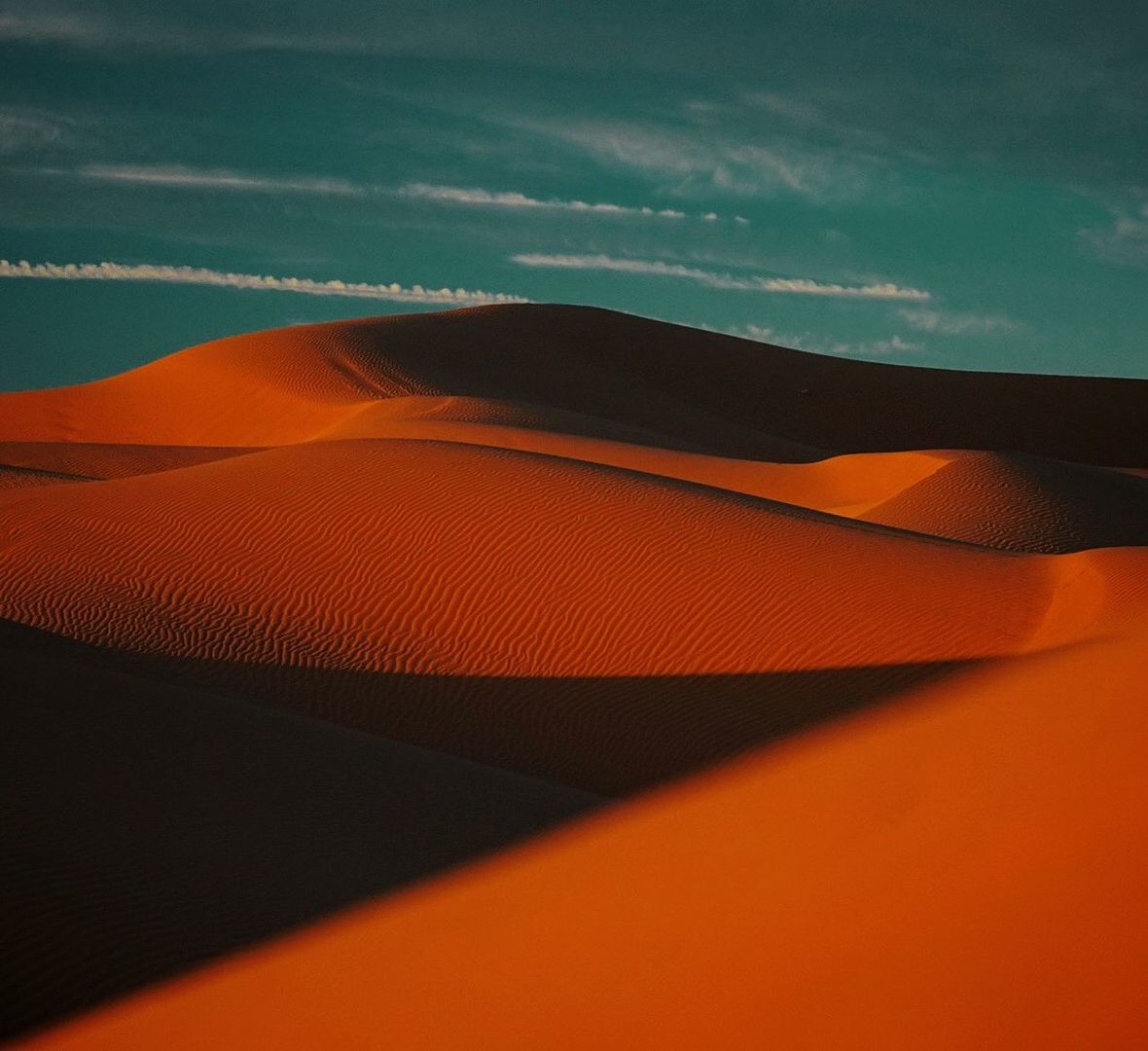 orange color, no people, beauty in nature, sand dune, nature, scenics - nature, sand, sky, close-up, sunlight, arid climate, outdoors, shadow, desert, day, pattern, environment, land, tranquility, cloud - sky, climate