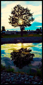 Scenic view of lake against cloudy sky