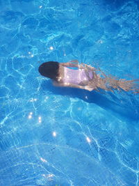 High angle view of woman swimming in pool