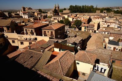 High angle view of houses in town against sky