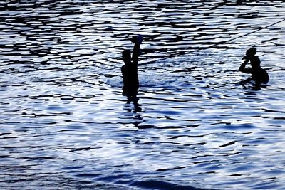 Silhouette of woman in swimming pool