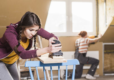 Young woman using mobile phone at home