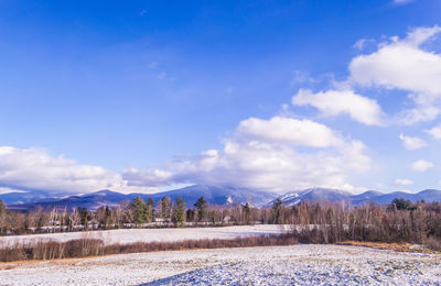 Scenic view of lafayette mountains against blue sky, sugar hill, nh