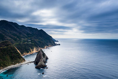 Southern kumomi coastline under an overcast morning sky creating a spectrum of azure tones.