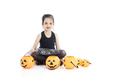 Portrait of smiling girl against white background