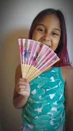 Portrait of smiling girl holding indoors