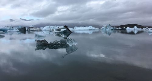 Scenic view of frozen lake against sky