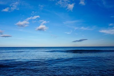 Scenic view of sea against blue sky